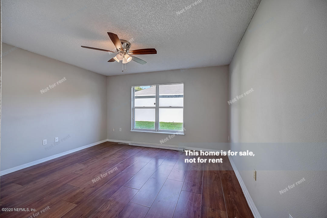 7115 High Bluff Road Jacksonville, FL 32244 - Photo 16 of 45 wooden floor in an empty room with a window