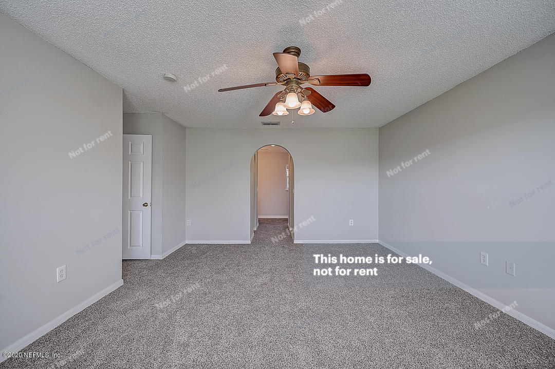 7115 High Bluff Road Jacksonville, FL 32244 - Photo 19 of 45 a view of a room with a ceiling fan and window