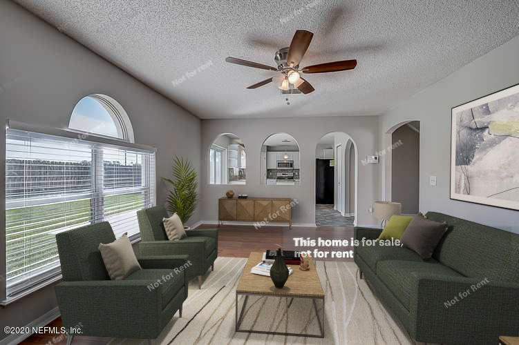 7115 High Bluff Road Jacksonville, FL 32244 - Photo 2 of 45 a living room with furniture and a large window