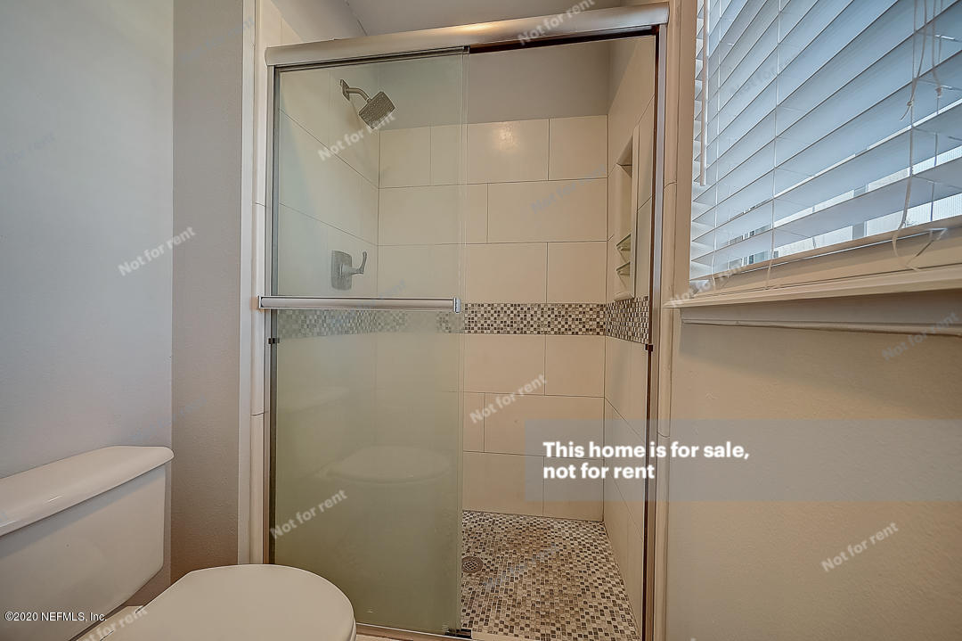 7115 High Bluff Road Jacksonville, FL 32244 - Photo 21 of 45 a bathroom with a shower and a toilet