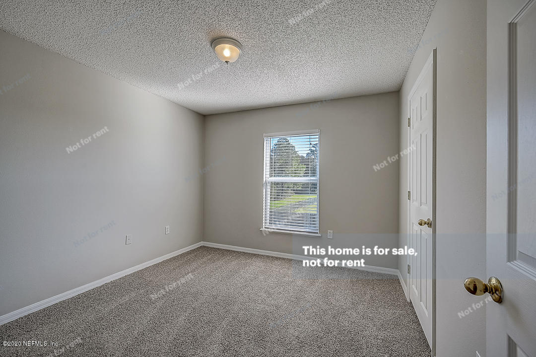 7115 High Bluff Road Jacksonville, FL 32244 - Photo 26 of 45 an empty room with a empty space and windows