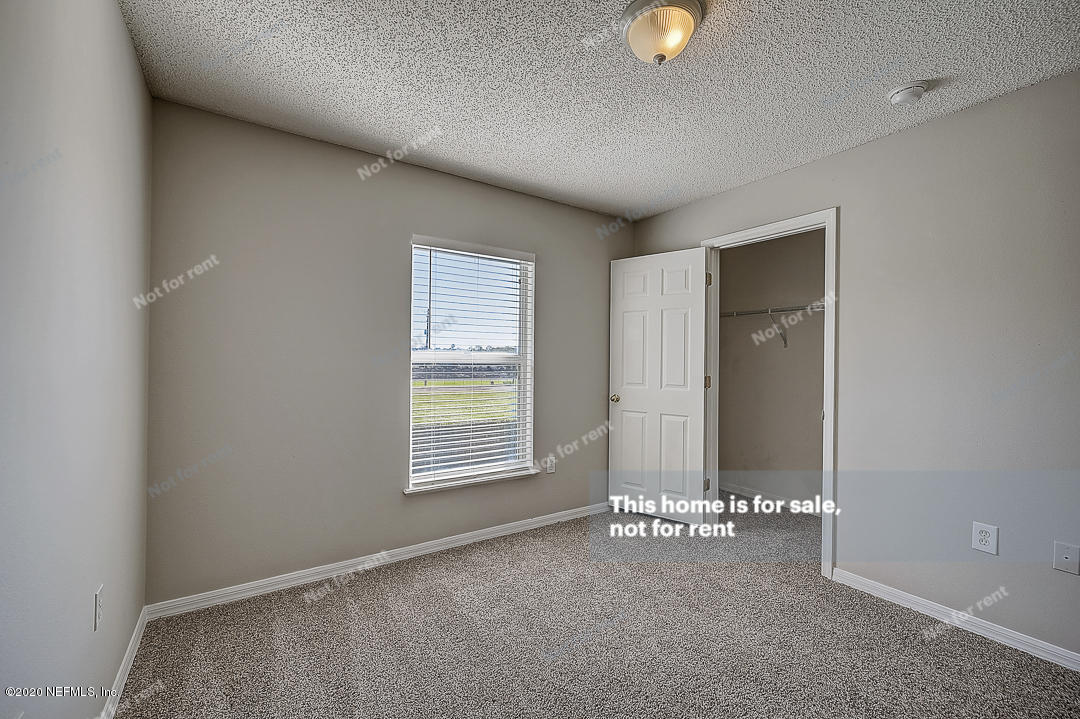 7115 High Bluff Road Jacksonville, FL 32244 - Photo 27 of 45 an empty room with windows and closet