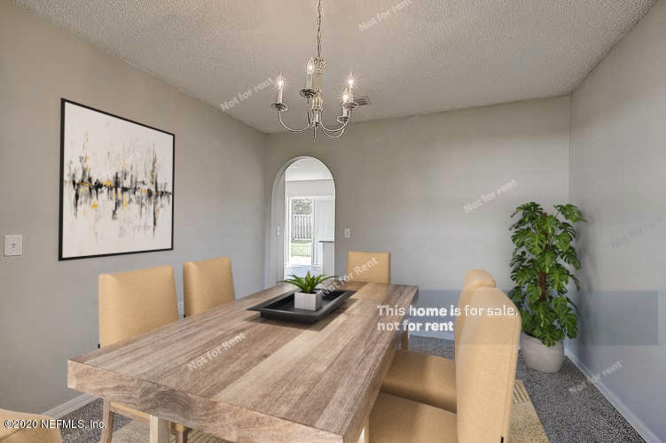 7115 High Bluff Road Jacksonville, FL 32244 - Photo 3 of 45 a bedroom with a large bed and a chandelier
