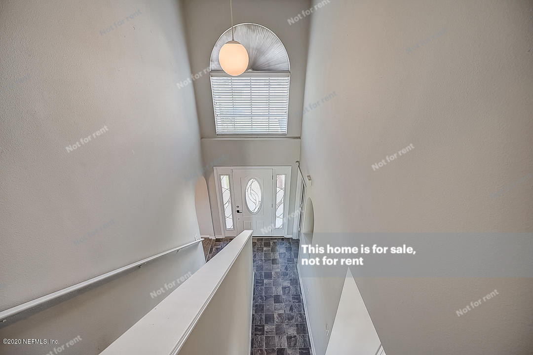 7115 High Bluff Road Jacksonville, FL 32244 - Photo 34 of 45 a view of a hallway with wooden floor and staircase