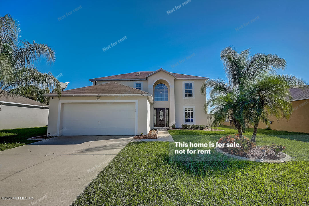 7115 High Bluff Road Jacksonville, FL 32244 - Photo 39 of 45 a front view of a house with a garden and yard
