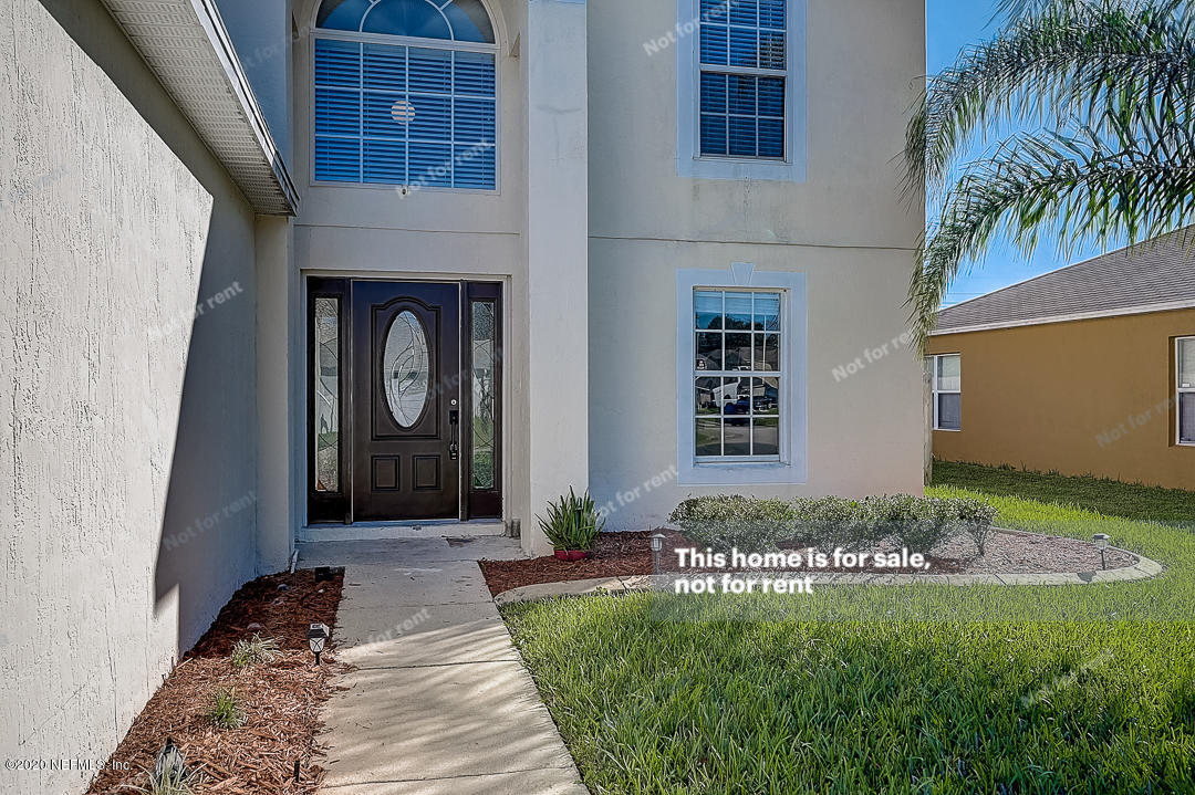 7115 High Bluff Road Jacksonville, FL 32244 - Photo 42 of 45 a front view of a house with garden