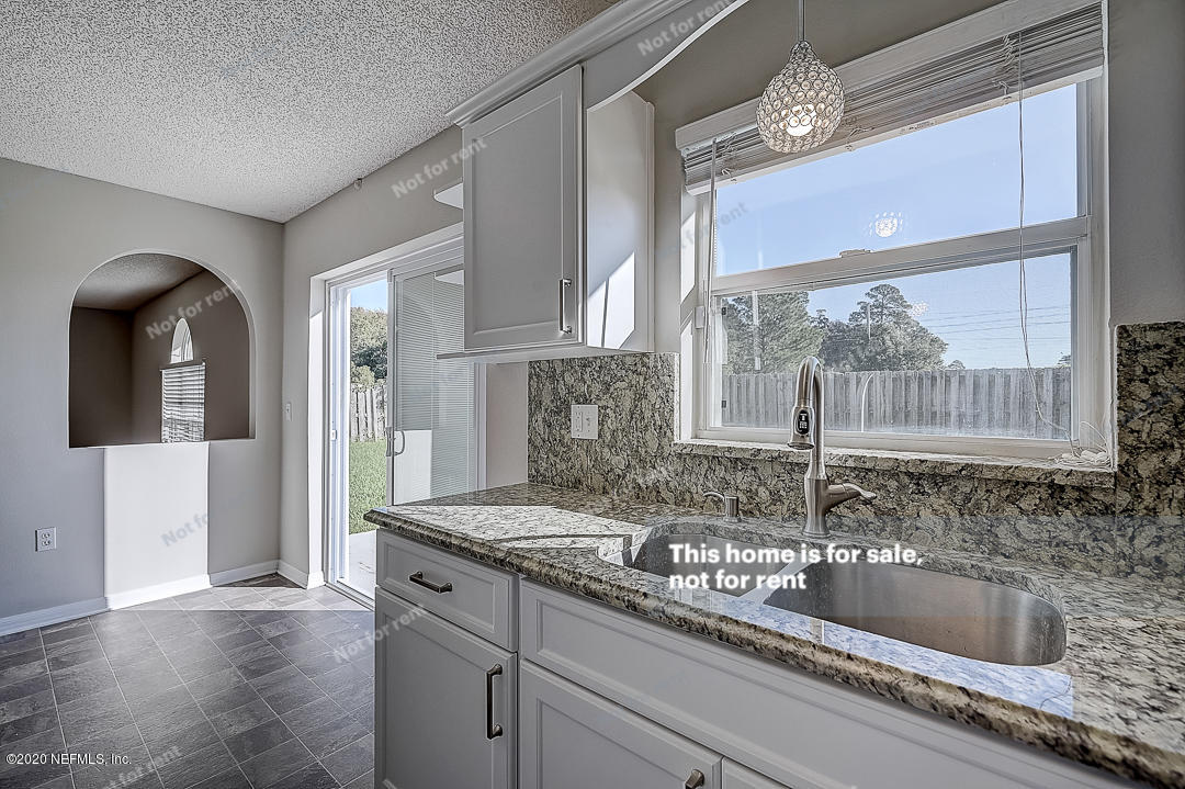7115 High Bluff Road Jacksonville, FL 32244 - Photo 8 of 45 a kitchen with granite countertop a sink and a window