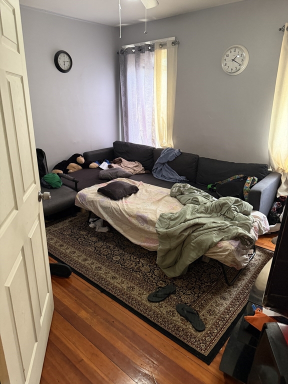 8 Ogden Street Boston, MA 02124 - Photo 10 of 20 a bed sitting in a bedroom next to a window