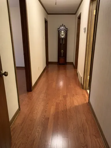 a view of hallway with wooden floor