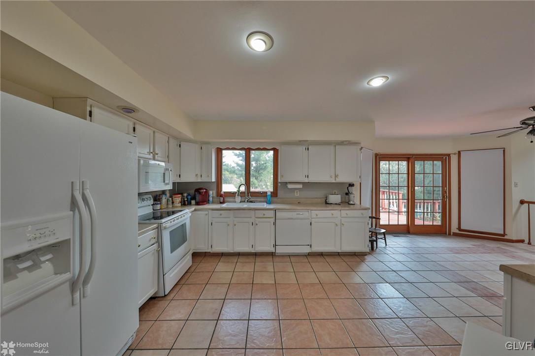 517 Roberts Road Nazareth, PA 18064 - Photo 28 of 50 a large white kitchen with a stove a sink dishwasher and a refrigerator