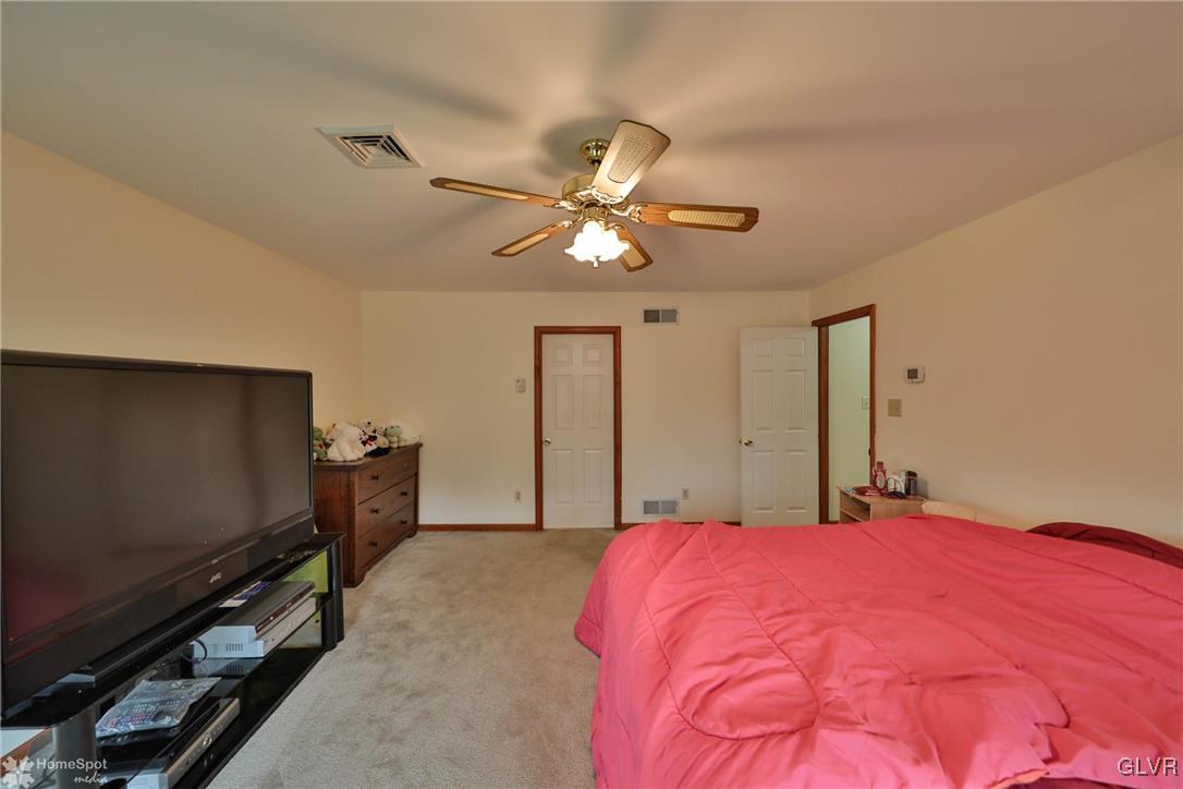 517 Roberts Road Nazareth, PA 18064 - Photo 41 of 50 a bedroom with a bed and a chandelier