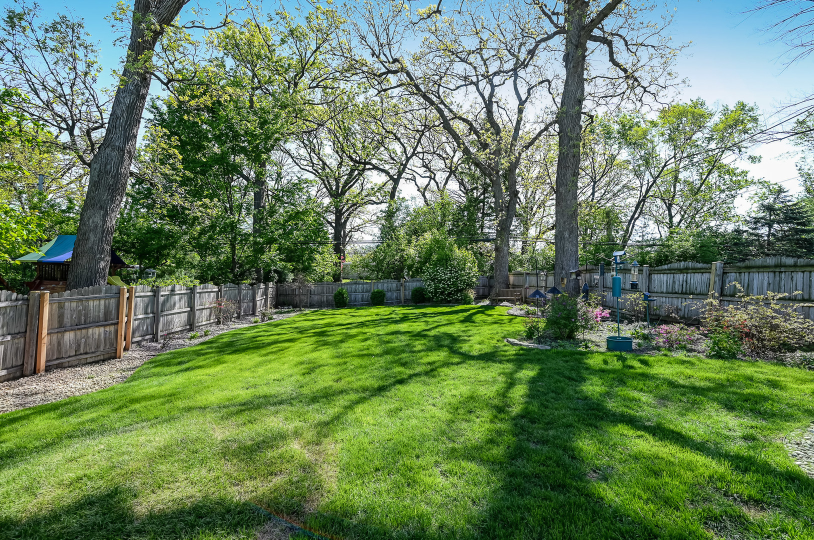 5607 Hillcrest Road Downers Grove, IL 60516 - Photo 42 of 50 a view of backyard with table and chairs and wooden fence