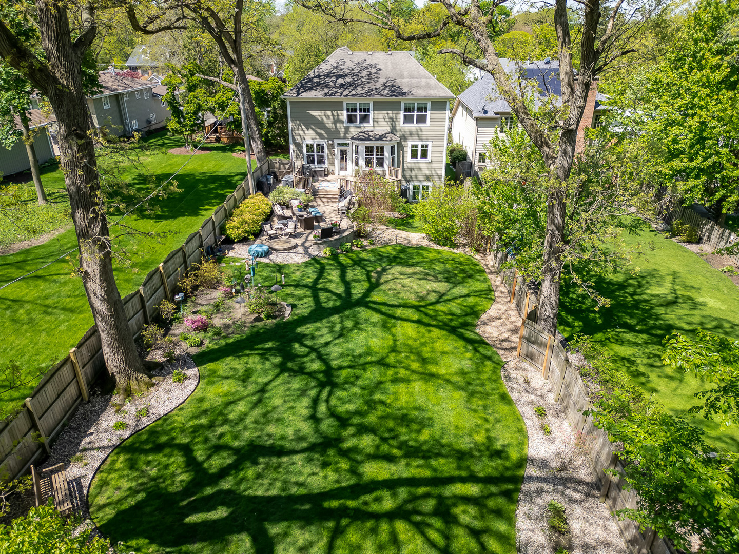 5607 Hillcrest Road Downers Grove, IL 60516 - Photo 46 of 50 a view of a big yard in front of a brick house with a small yard