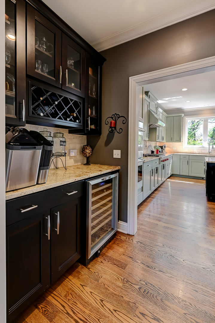 5607 Hillcrest Road Downers Grove, IL 60516 - Photo 9 of 50 a kitchen with a sink cabinets and wooden floor