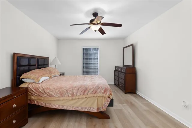 a bedroom with a large bed and a chandelier