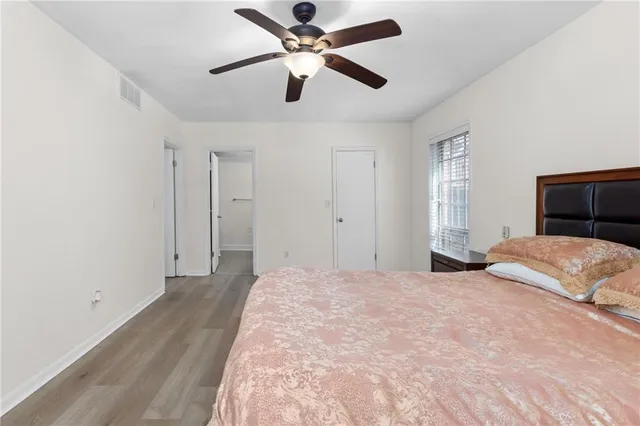 walk in closet with wooden floor
