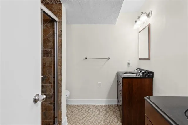 a bathroom with a toilet and a shower