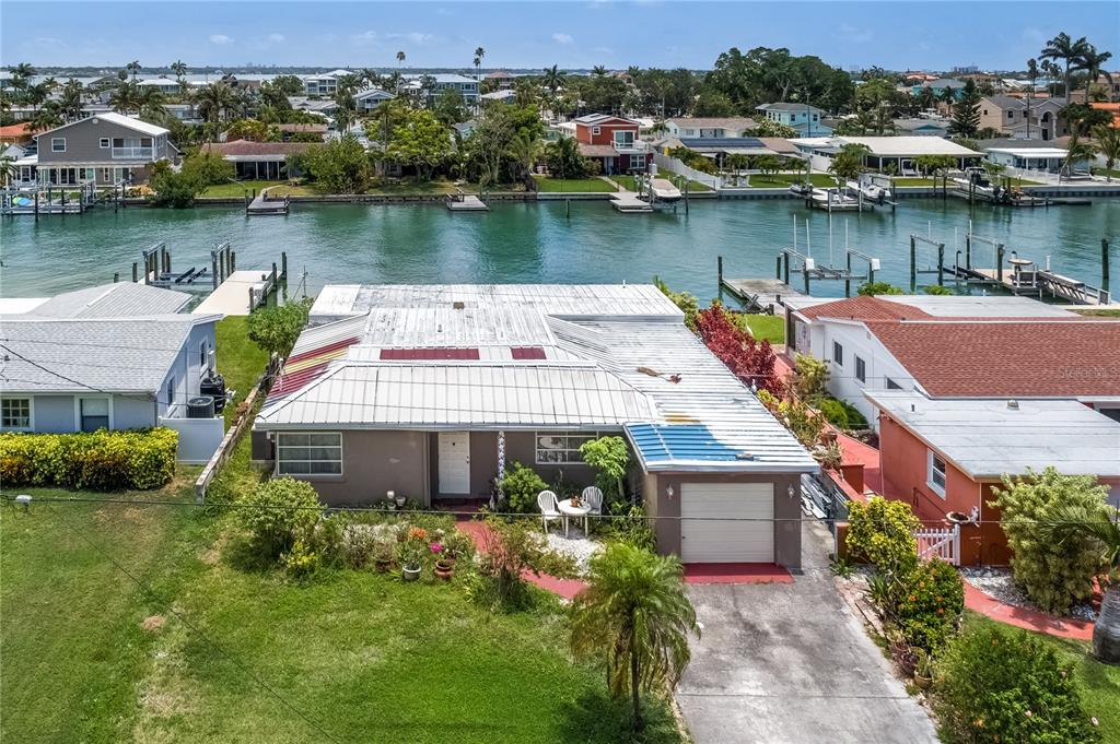an aerial view of a house with a yard and lake view