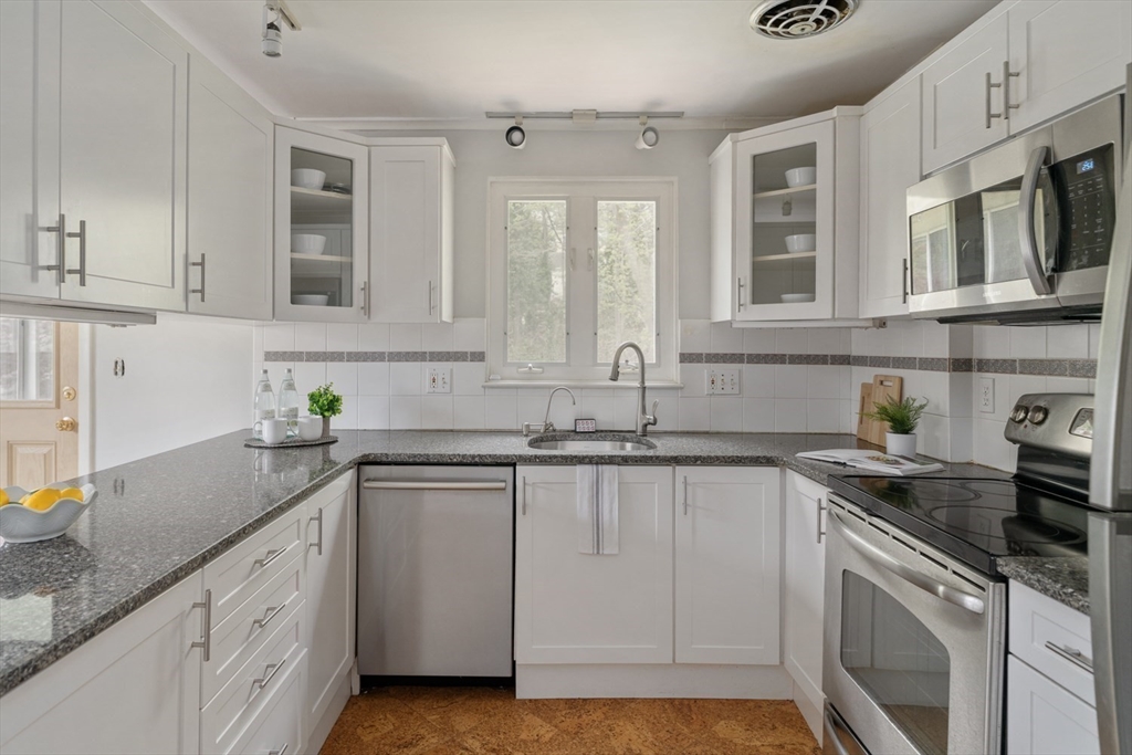 22 Rambler Road Boston, MA 02130 - Photo 11 of 28 a kitchen with stainless steel appliances granite countertop a sink stove and cabinets