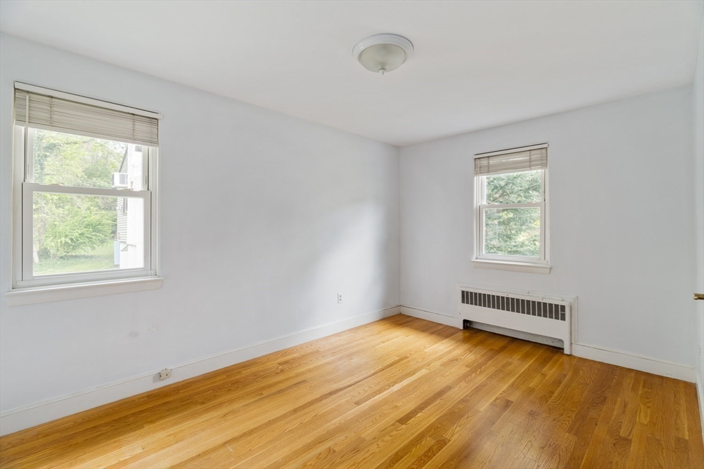 22 Rambler Road Boston, MA 02130 - Photo 17 of 28 a view of an empty room with wooden floor and a window