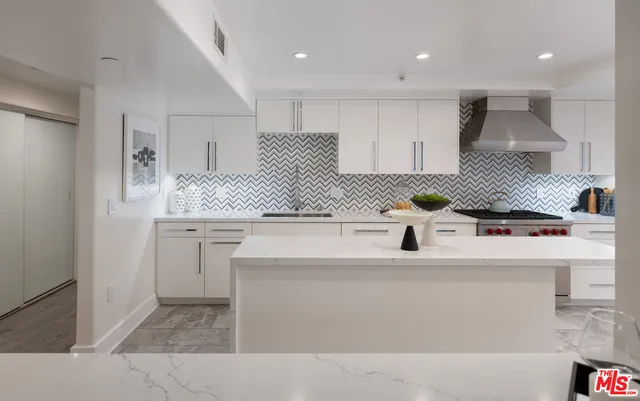 a kitchen with stainless steel appliances granite countertop a sink and a stove