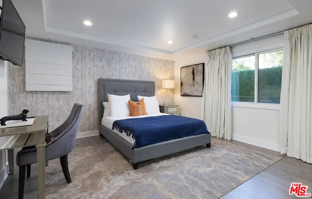 a bedroom with a bed and a table in it