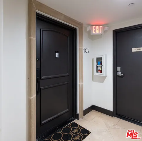 a view of a hallway with wooden floor and a cabinet