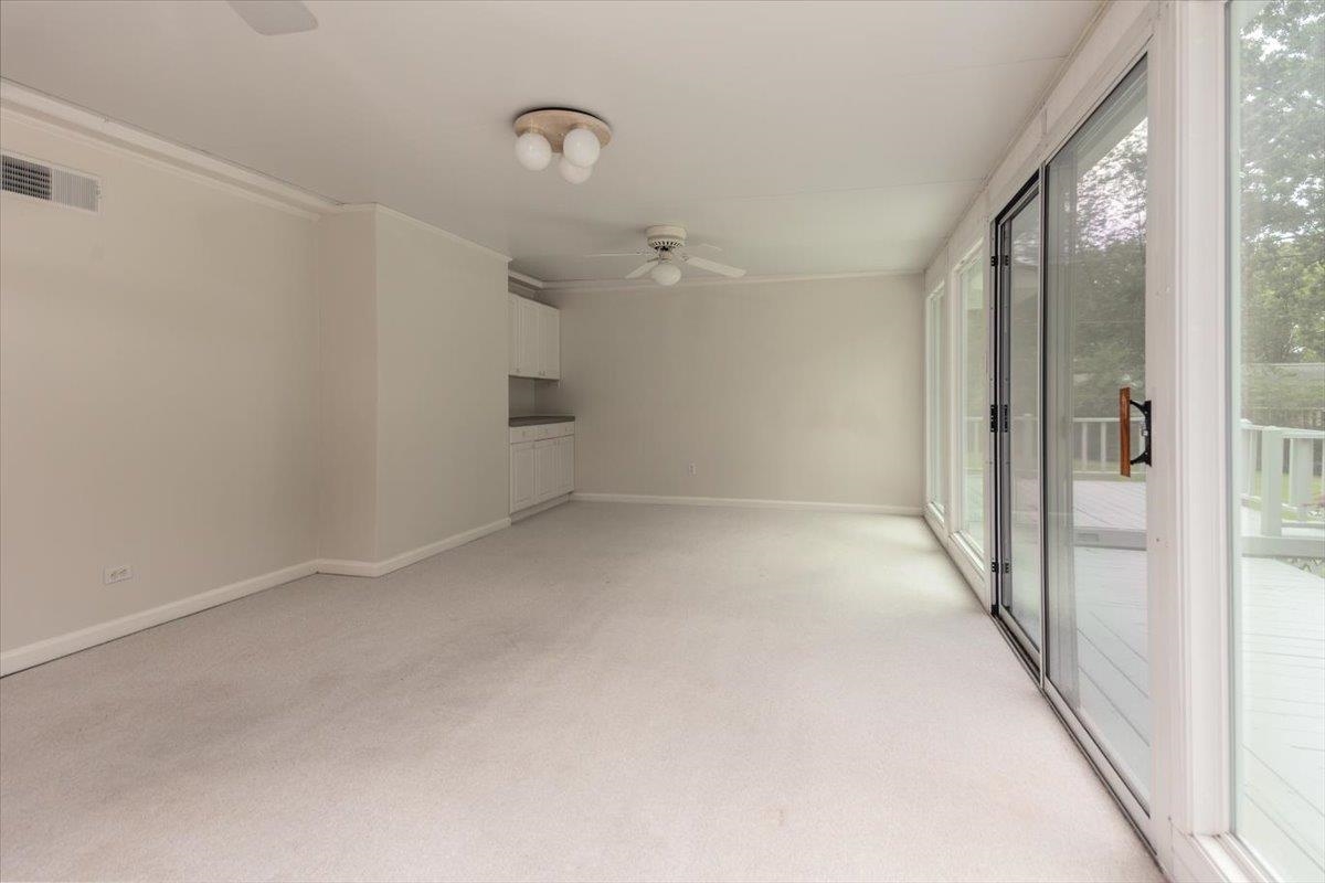 670 Peterson Lake Road Collierville, TN 38017 - Photo 10 of 37 Room with a wall of sliding glass doors opening onto a deck