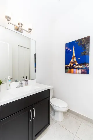 a bathroom with a toilet a sink and mirror