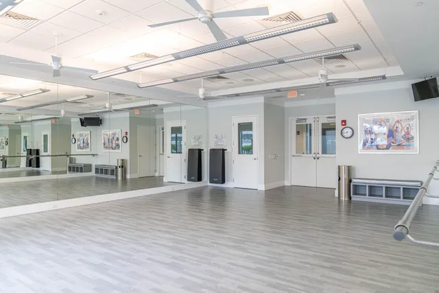 a view of a living room and kitchen with furniture wooden floor