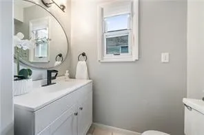 a bathroom with a sink a toilet and mirror