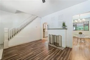 a view of entryway and hall with wooden floor