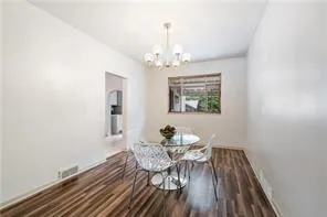 a view of a dining room with furniture wooden floor and chandelier