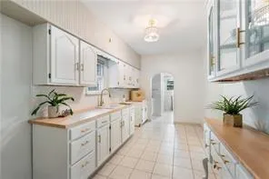 a kitchen with a white cabinets and window