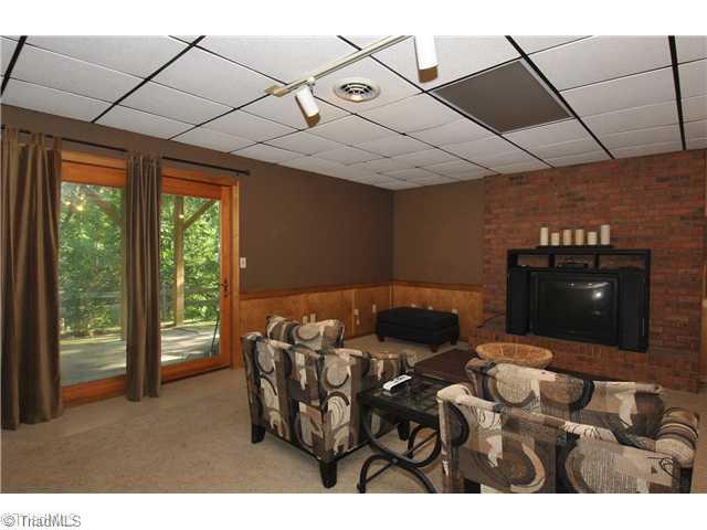 4929 Country Ridge Road Clemmons, NC 27012 - Photo 10 of 14 Den/Family/Great Room. Walk-out daylight basement features den w/masonry fireplace, bath.