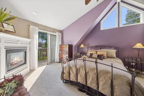 a bedroom with a bed a table and chair