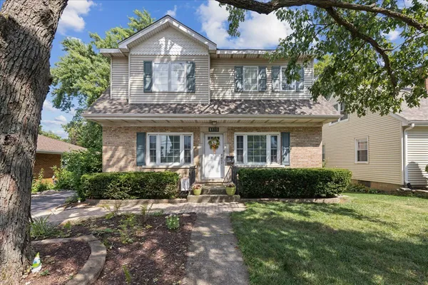 a view of a house with a backyard and garden