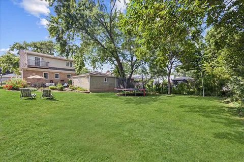 a view of a house with a yard balcony and sitting area