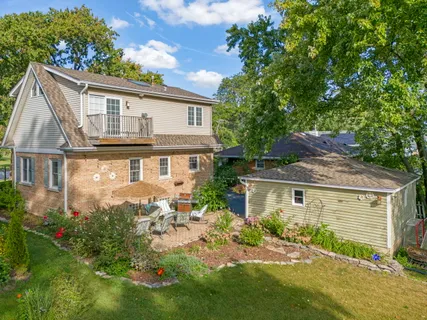 an aerial view of a house with yard swimming pool and outdoor seating