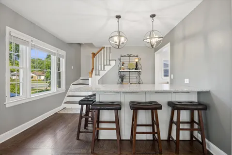 a living room with furniture a window and a chandelier