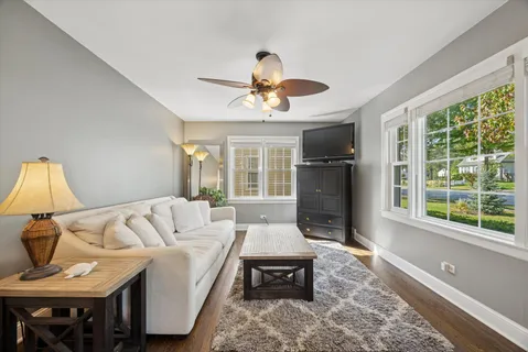 a living room with furniture a window and a flat screen tv