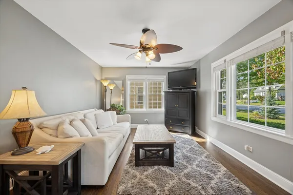 a living room with furniture a window and a flat screen tv