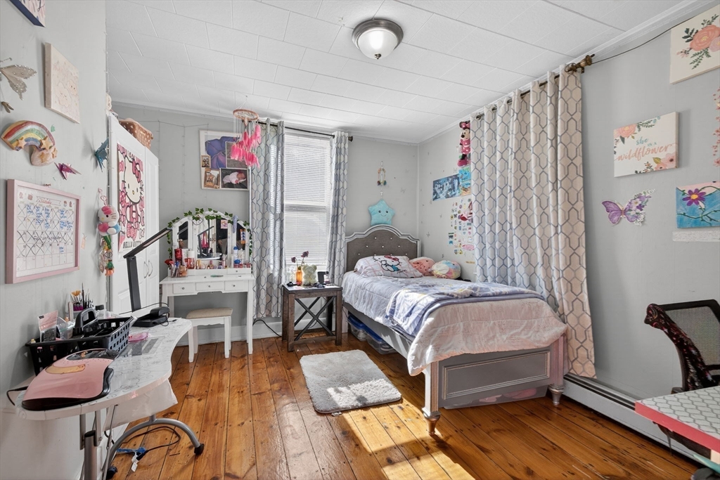 6 Morris Street Lynn, MA 01905 - Photo 12 of 36 a bedroom with furniture and a wooden floor
