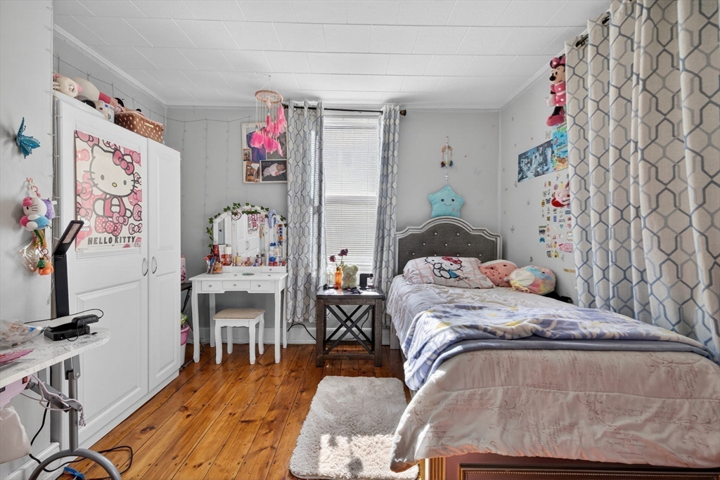 6 Morris Street Lynn, MA 01905 - Photo 13 of 36 a bedroom with a bed and furniture