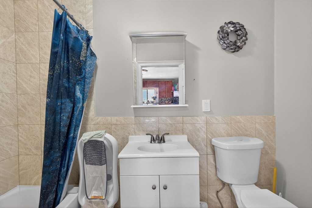 6 Morris Street Lynn, MA 01905 - Photo 14 of 36 a bathroom with a toilet sink and mirror
