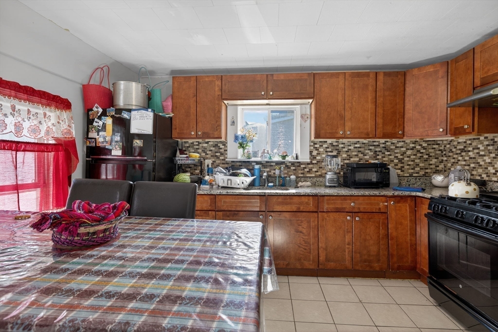 6 Morris Street Lynn, MA 01905 - Photo 18 of 36 a kitchen with stainless steel appliances granite countertop a sink stove and cabinets