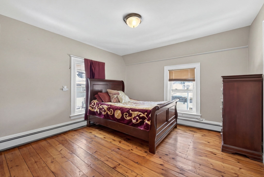 6 Morris Street Lynn, MA 01905 - Photo 24 of 36 a bedroom with a bed and wooden floor