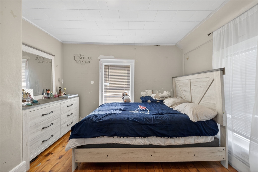 6 Morris Street Lynn, MA 01905 - Photo 25 of 36 a bedroom with a bed and mirror