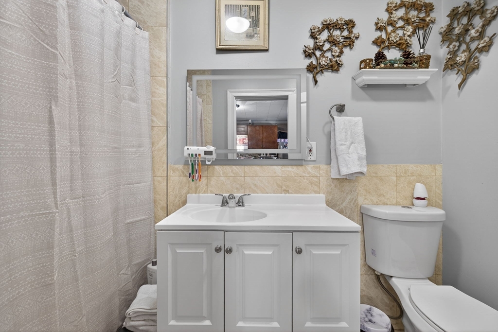 6 Morris Street Lynn, MA 01905 - Photo 26 of 36 a bathroom with a sink vanity mirror and toilet