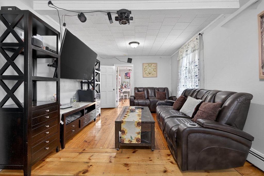 6 Morris Street Lynn, MA 01905 - Photo 7 of 36 a living room with furniture and a flat screen tv